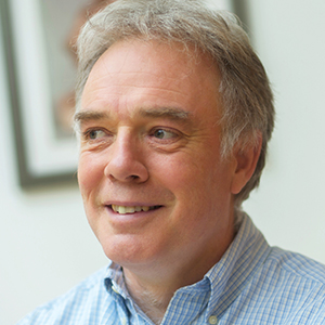 Head shot of Nick Robertson smiling and looking away from camera