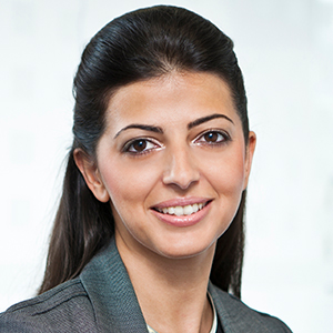 Headshot of Paula Abrahamian wearing a grey jacket looking into the camera