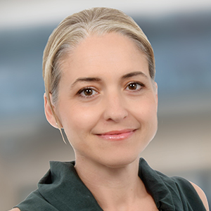 Head shot of Kal Karaiskaki smiling into camera