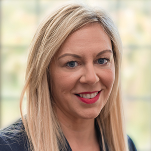 Head shot of Louise Bennett smiling into camera