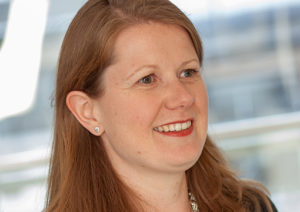 Head shot of Claire O'Flinn smiling and looking away from camera