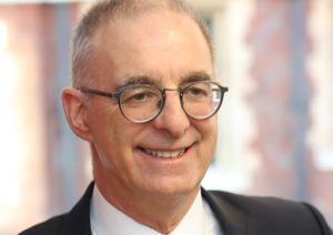 Head shot of Gerard Cukier smiling and looking away from camera