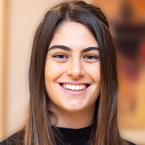 Head shot of Courtney Adderley smiling into camera