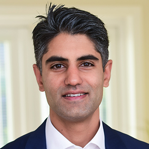 Headshot of Ajay Rana wearing a suit looking at the camera