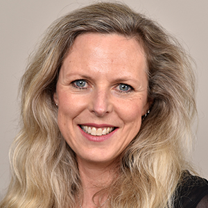 Head shot of Carolyn Banes smiling into camera