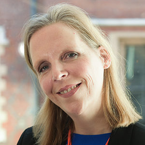 Headshot of Claudia Otto tilting her head looking at the camera