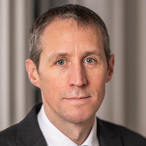 Headshot of Paul McCourt wearing a suit looking at the camera