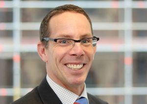 Head shot of Toby Ward smiling into camera