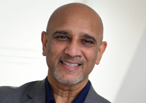 Head shot of Minesh Patel smiling into camera