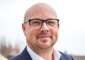 Head shot of Jon Olson-Welsh smiling into camera