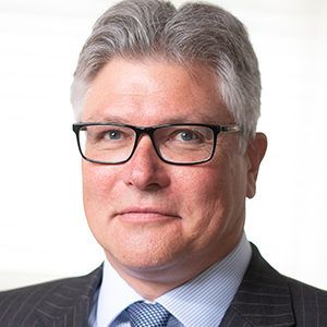 Headshot of Gregor Kleinknecht wearing a suit looking at the camera