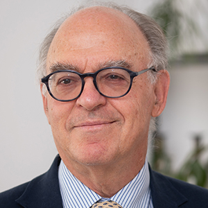 Headshot of Isaac Felberbaum wearing a suit lookin at the camera